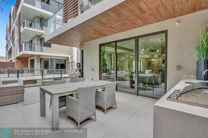 Corner townhouse-condo with floor-to-ceiling windows.