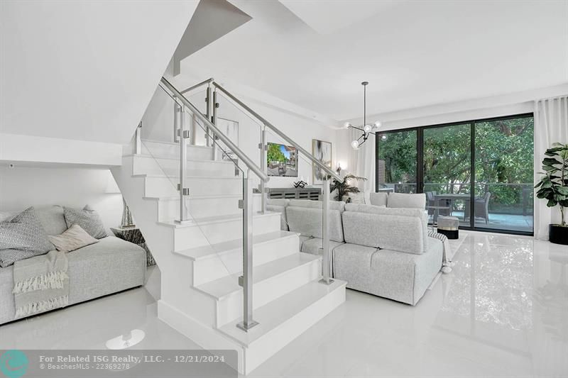 Corner townhouse-condo with floor-to-ceiling windows.