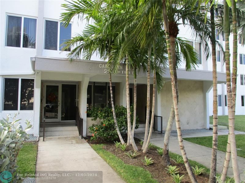 main entrance to condo is in the middle of the block behind the fence