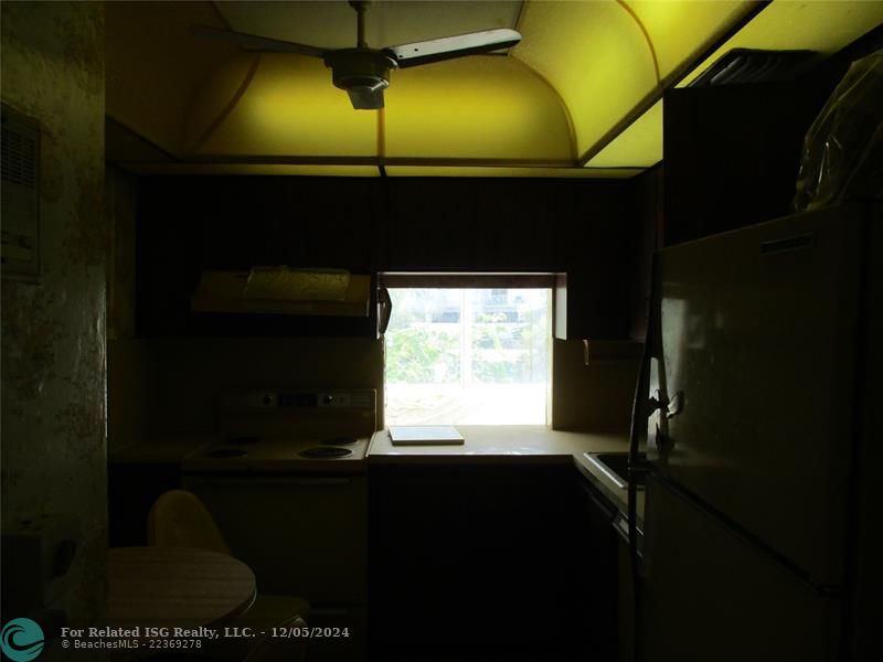 domed ceiling in kitchen with avocado appliances that may or may not work...as is sale.  Owner inherited condo