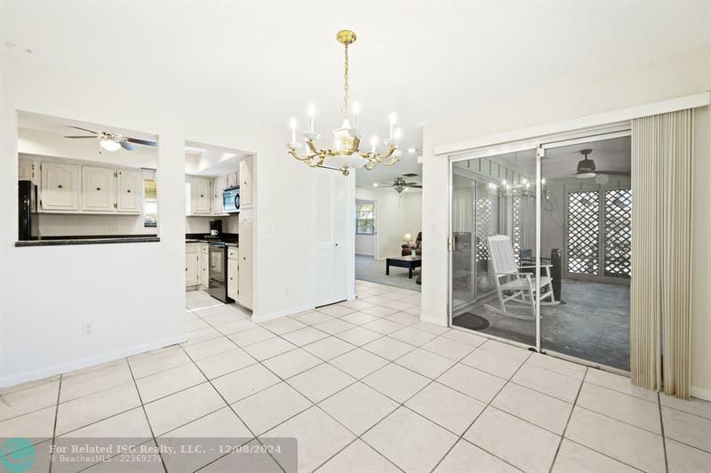 Dining room to kitchen, sliding doors to screened porch and entry to Family room