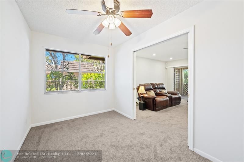 Den open up to Family room with double pocket doors