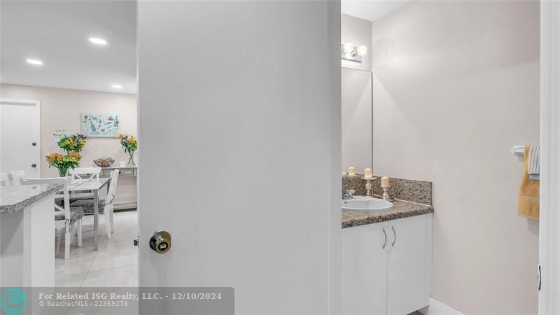 Granie snack counters and ample cabinets in this bright eat in kitchen