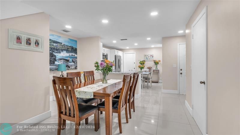 Granie snack counters and ample cabinets in this bright eat in kitchen