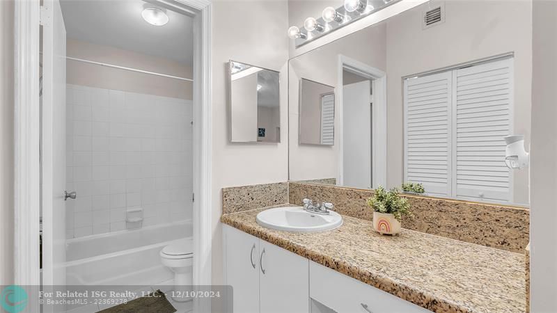 Granie snack counters and ample cabinets in this bright eat in kitchen