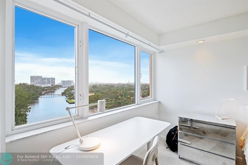 work area inside primary bedroom with water views