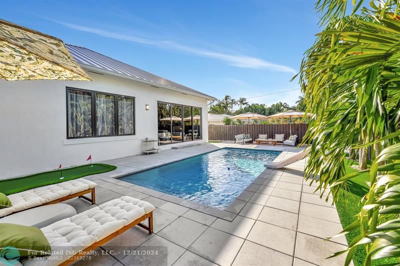 The backyard is an outdoor oasis, designed for ultimate relaxation and entertainment! The centerpiece is the sparkling pool surrounded by a spacious patio, perfect for sunbathing or hosting gatherings.