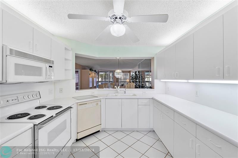 Large kitchen with lots of cabinet space and a desk.