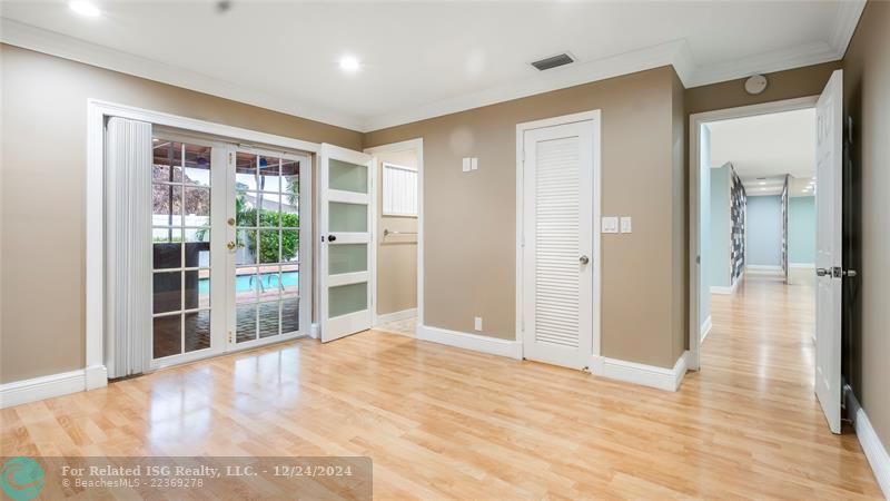 Large Primary with walk in closet and french doors to backyard oasis & pool