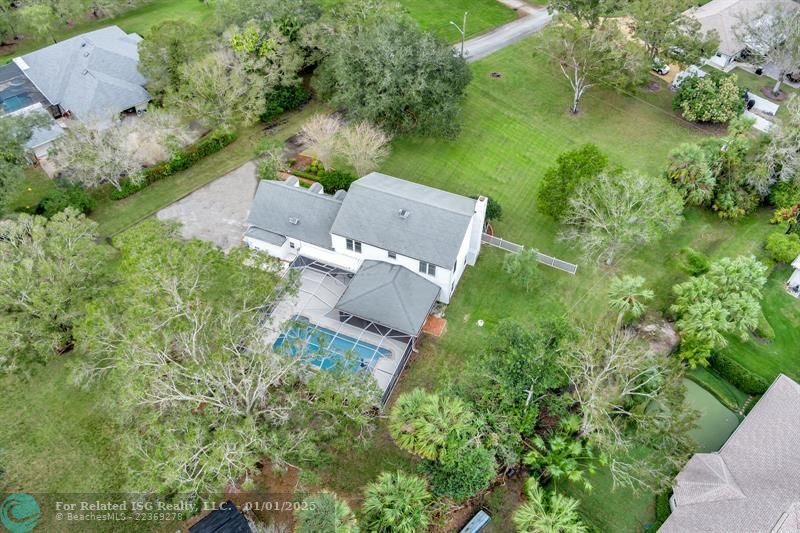 Back of home with spacious over an acre land, privacy, pool and so much more