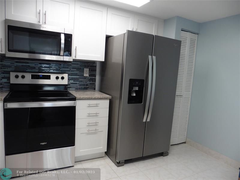 Pantry closet next to refrigerator.